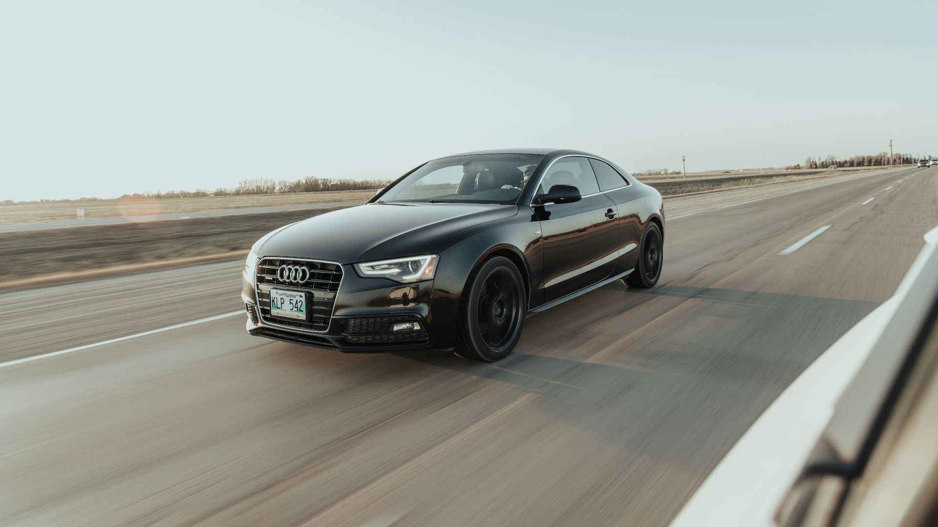 black audi sedan on road during daytime