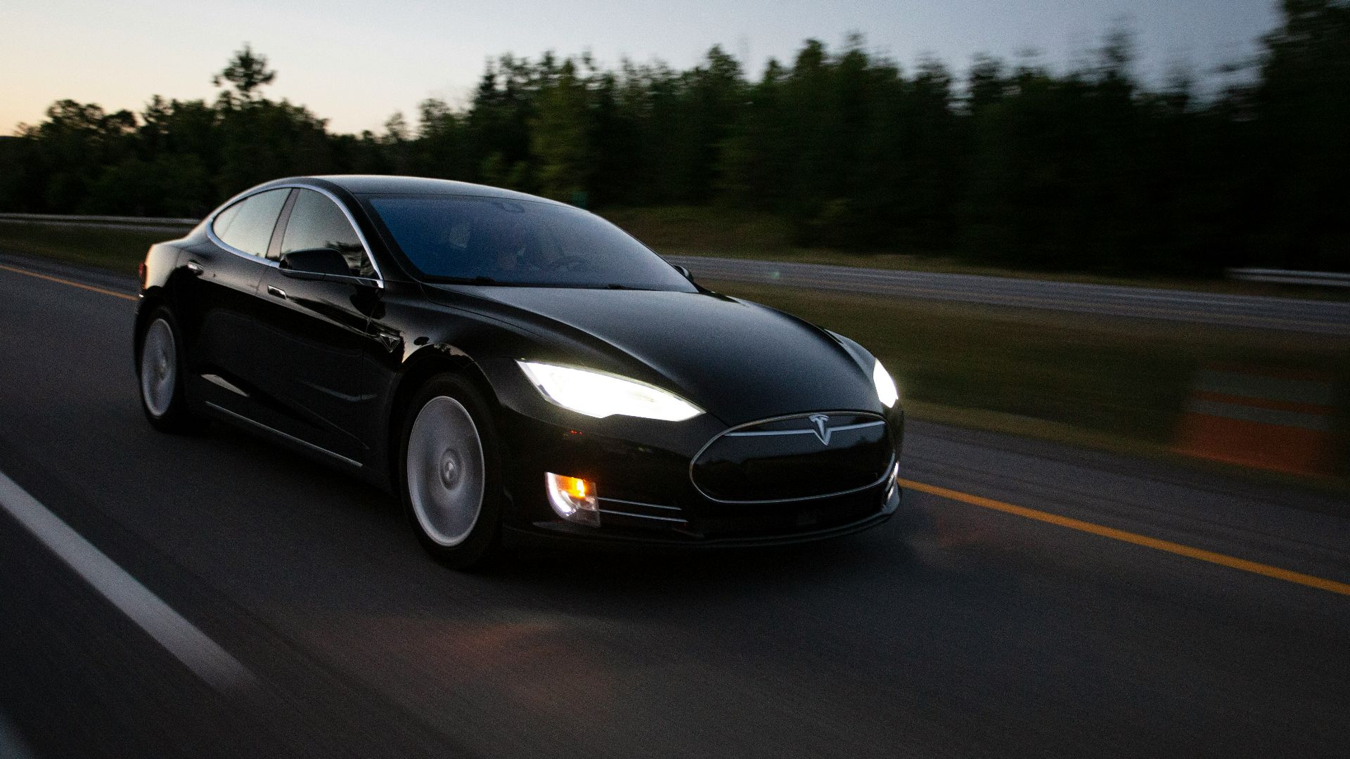 time-lapse photography of black sedan on road