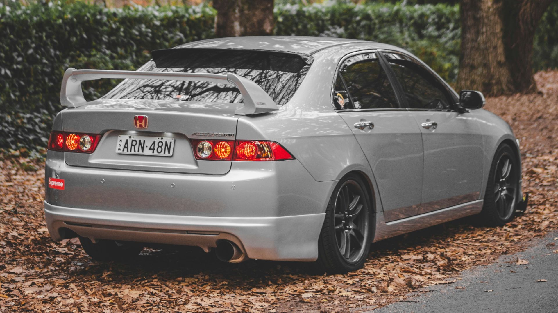 black porsche 911 on road near trees during daytime