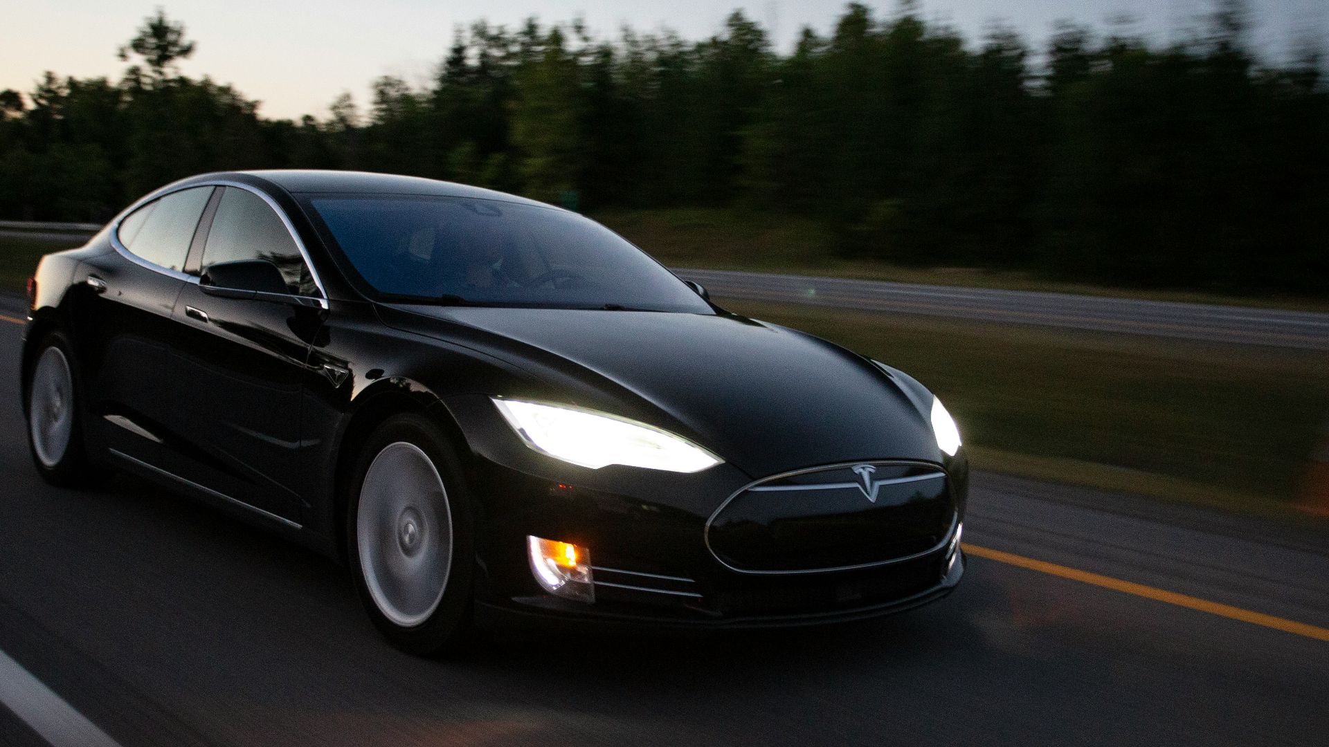 time-lapse photography of black sedan on road