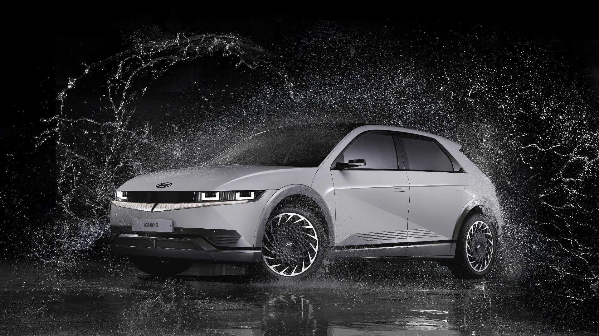 a white car is splashing in the water