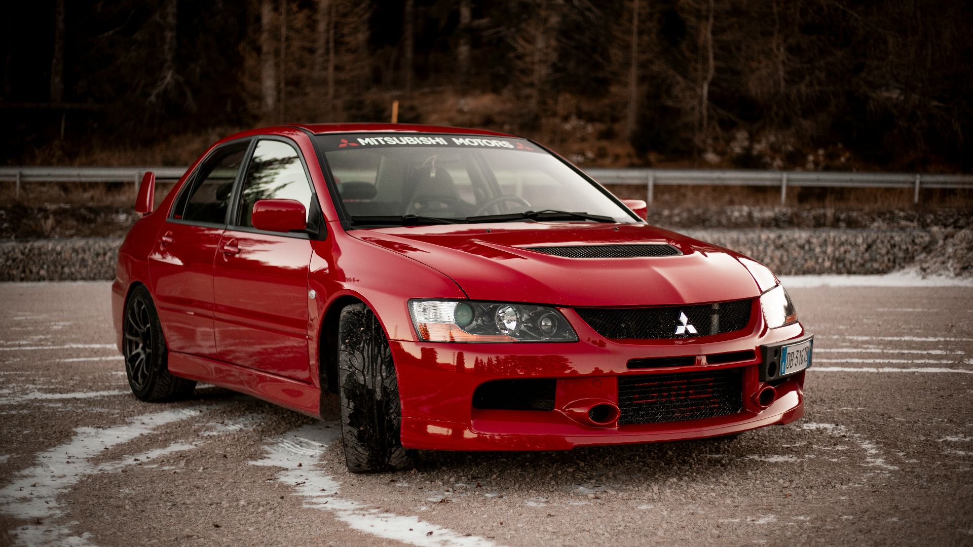 red chevrolet camaro on road during daytime