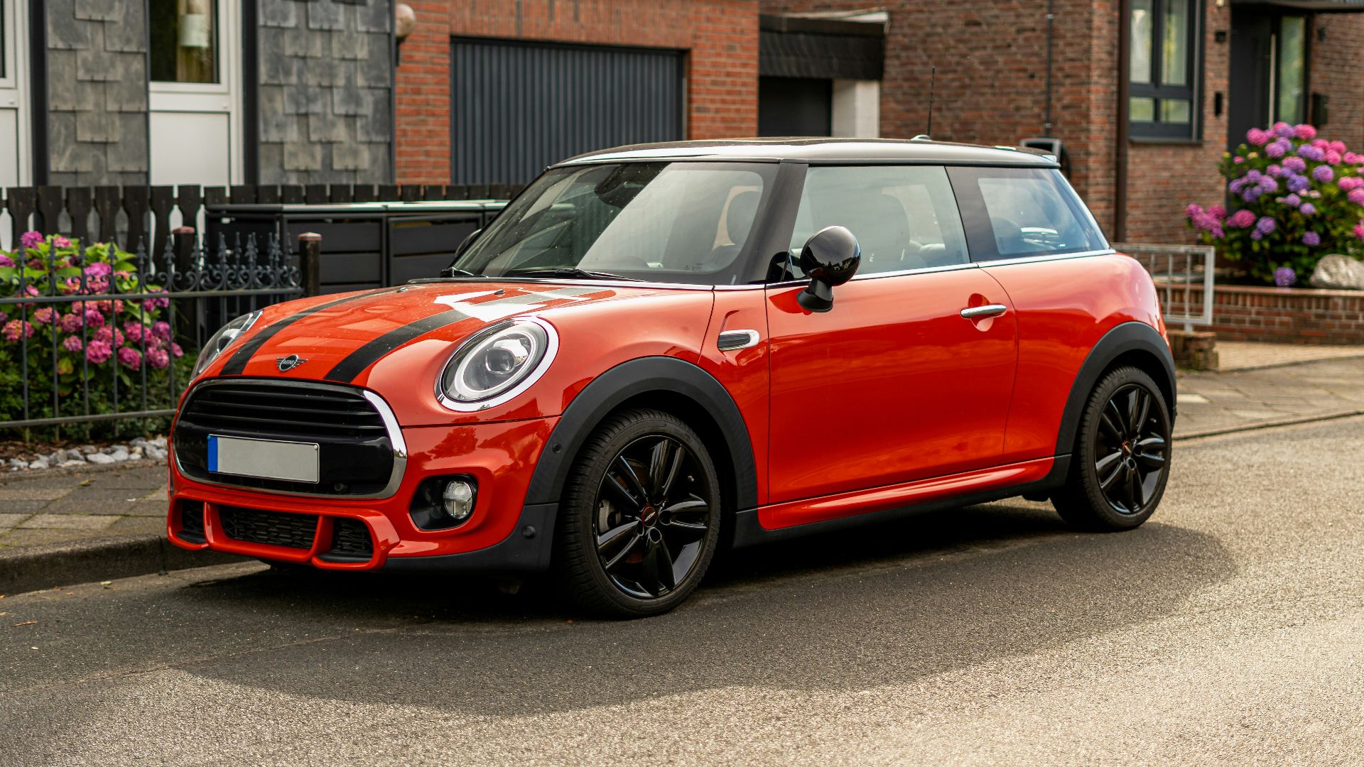 A red mini cooper parked on the side of the road