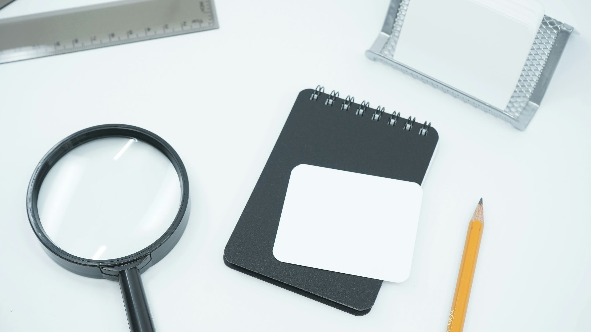 black magnifying glass on white paper