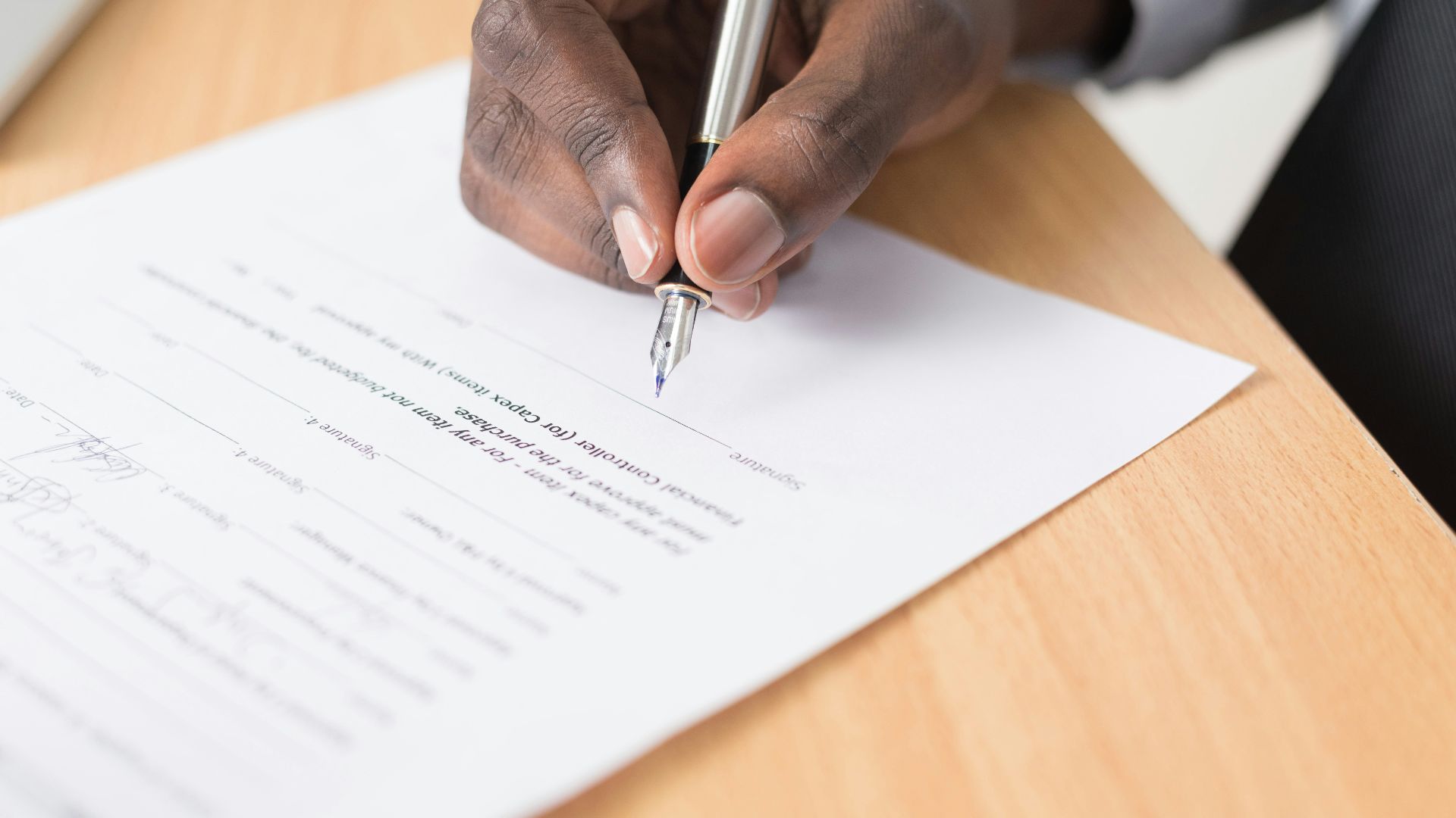 person writing on white paper