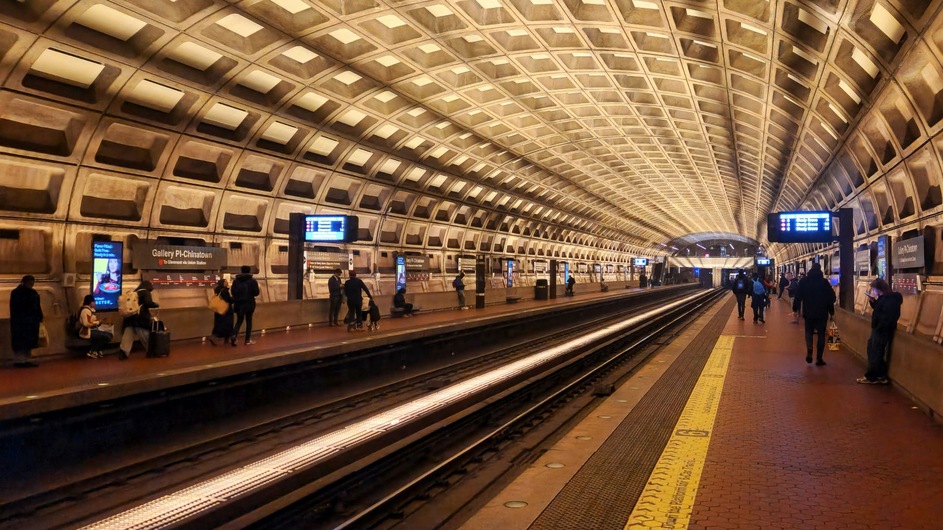 A subway station with people waiting for the train