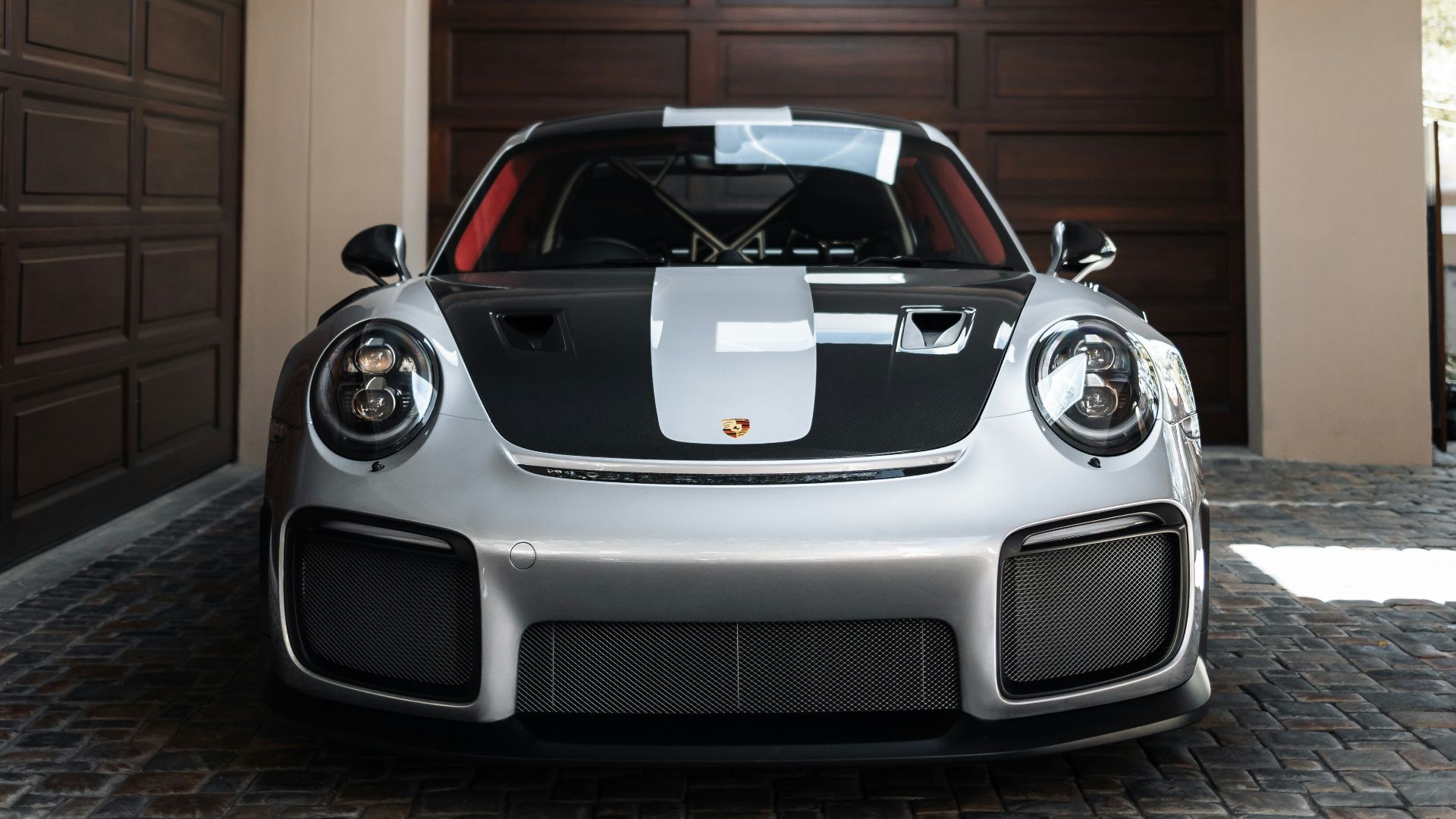 a white and black sports car parked in a garage