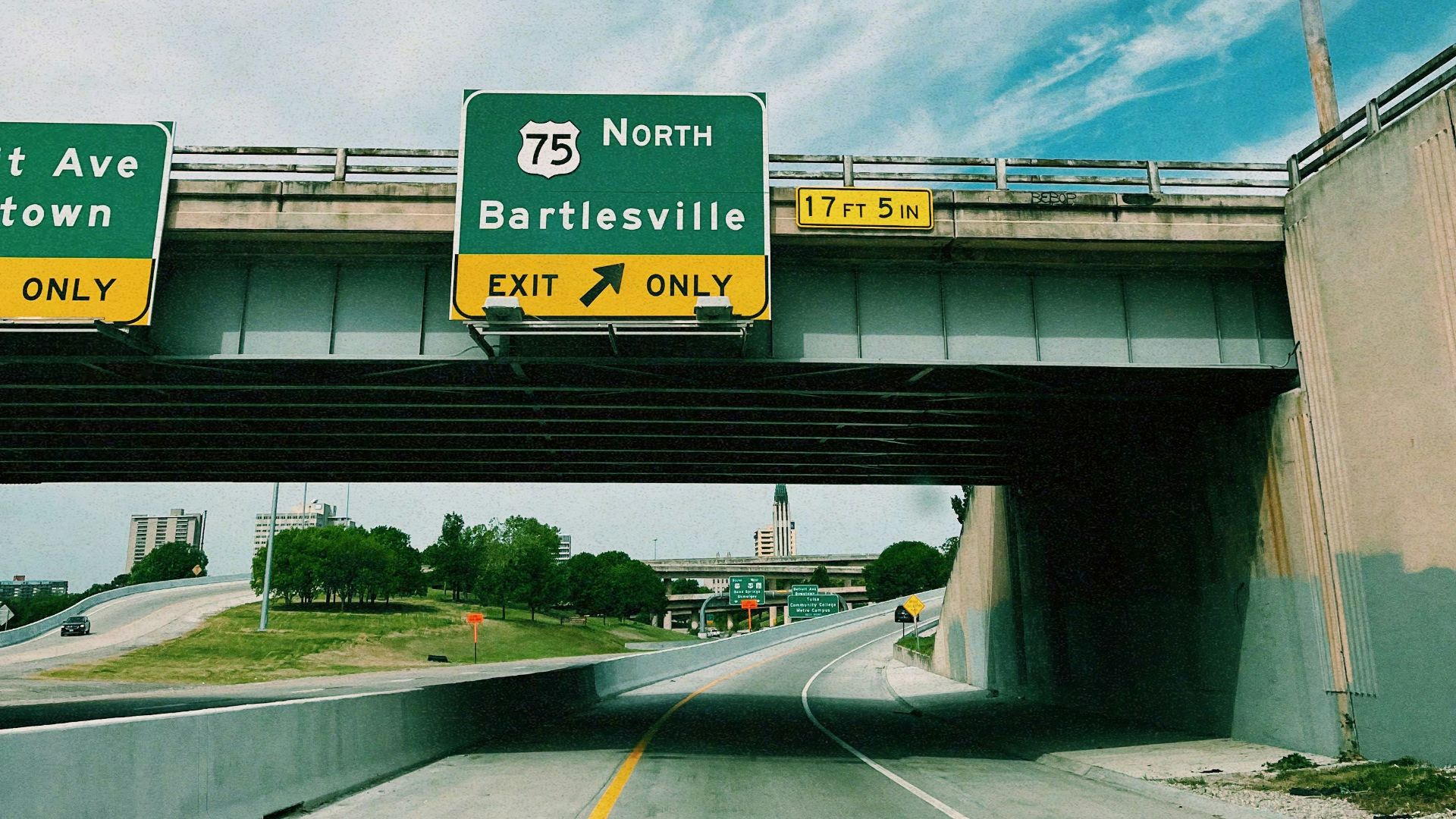 a highway with two freeway signs above it