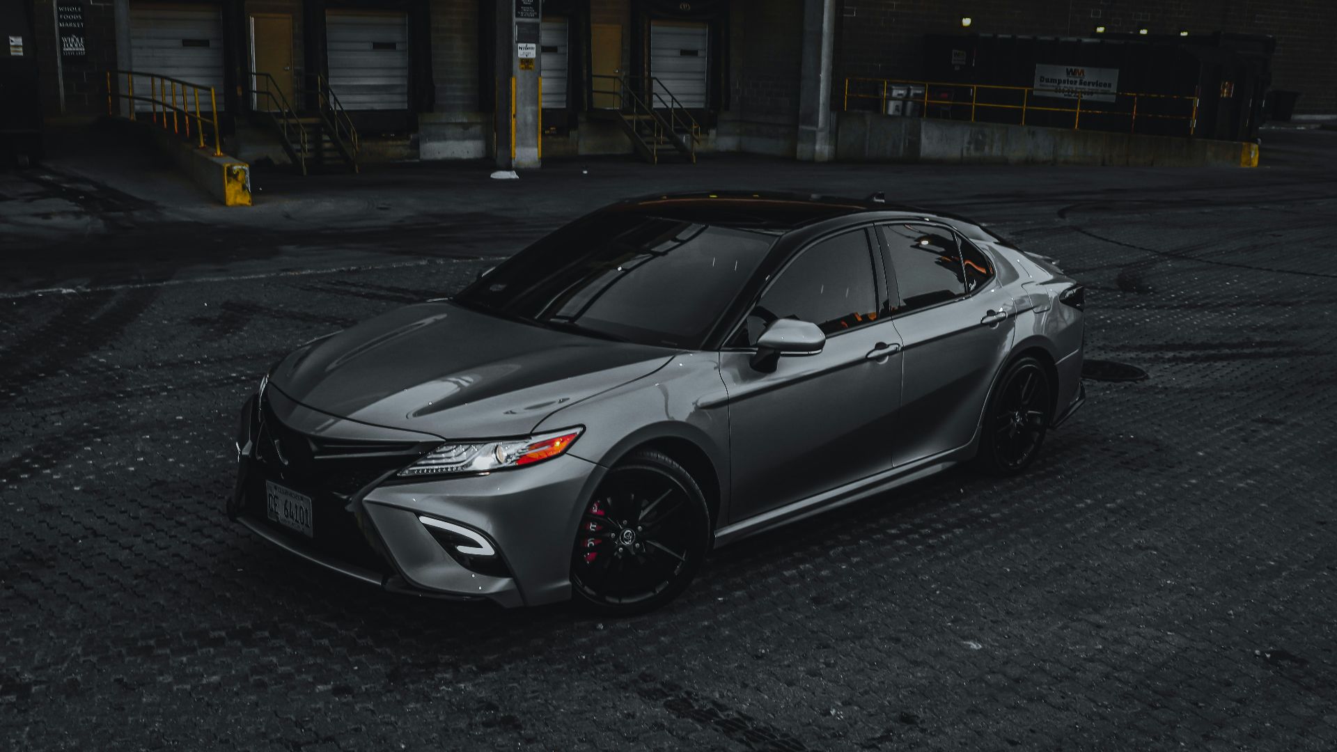 silver sedan parked on road during daytime