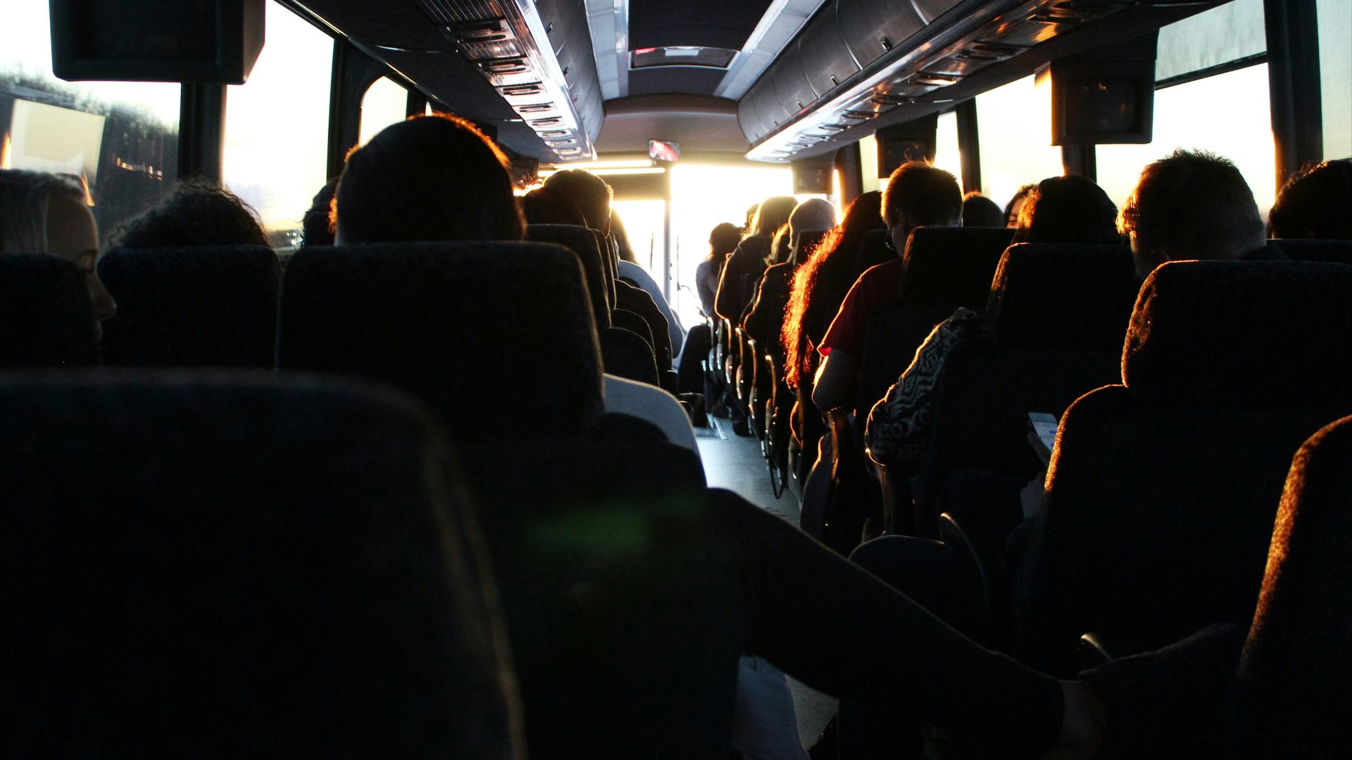 people riding passenger bus during daytime