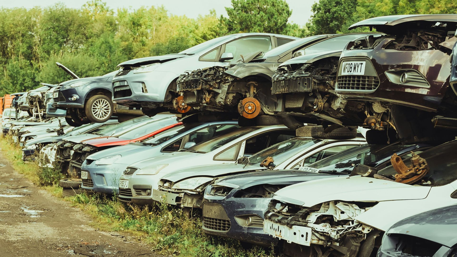 a bunch of cars that are sitting in the dirt