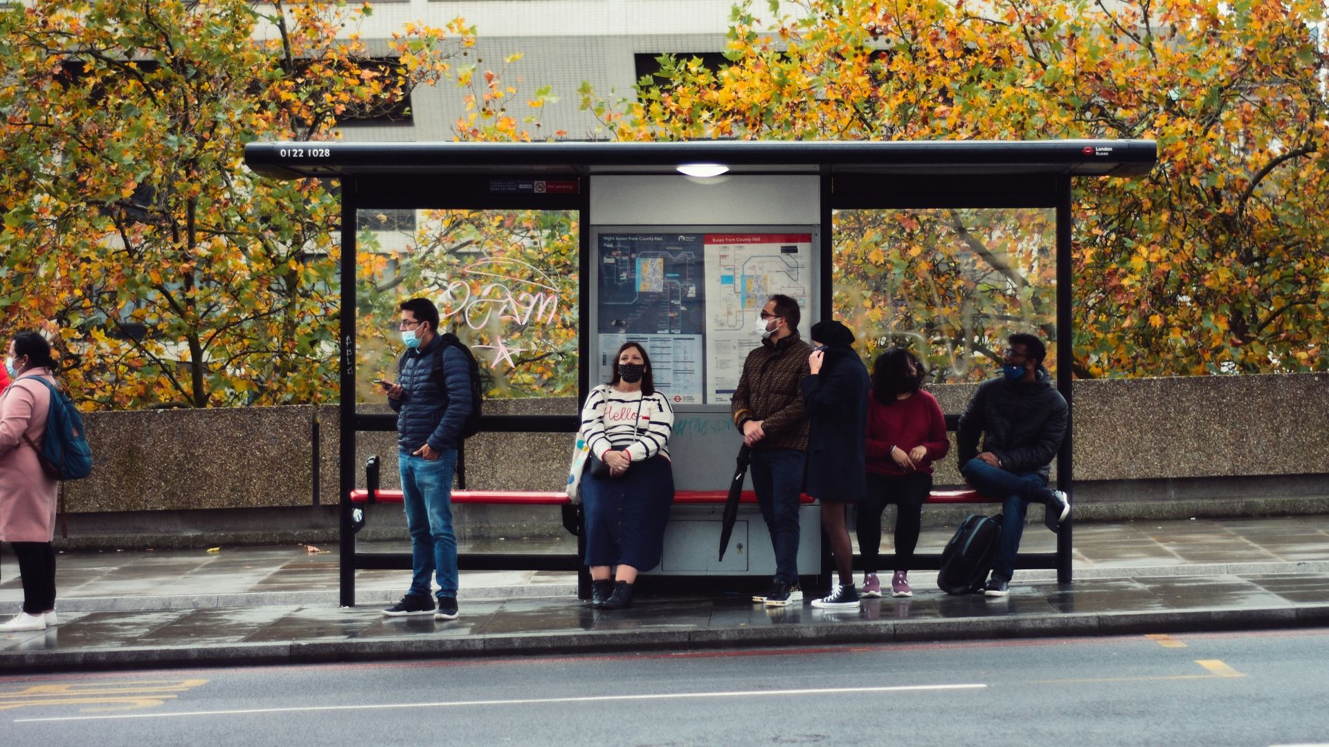 people sitting on bench in front of building during daytime