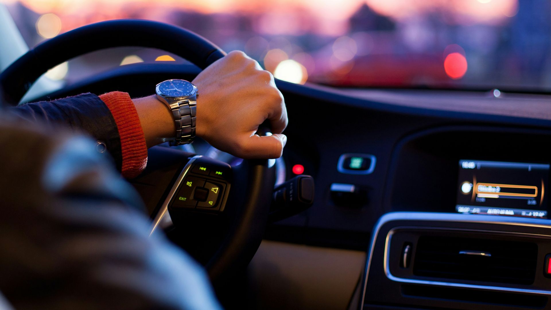 man driving a car wearing wrist watch
