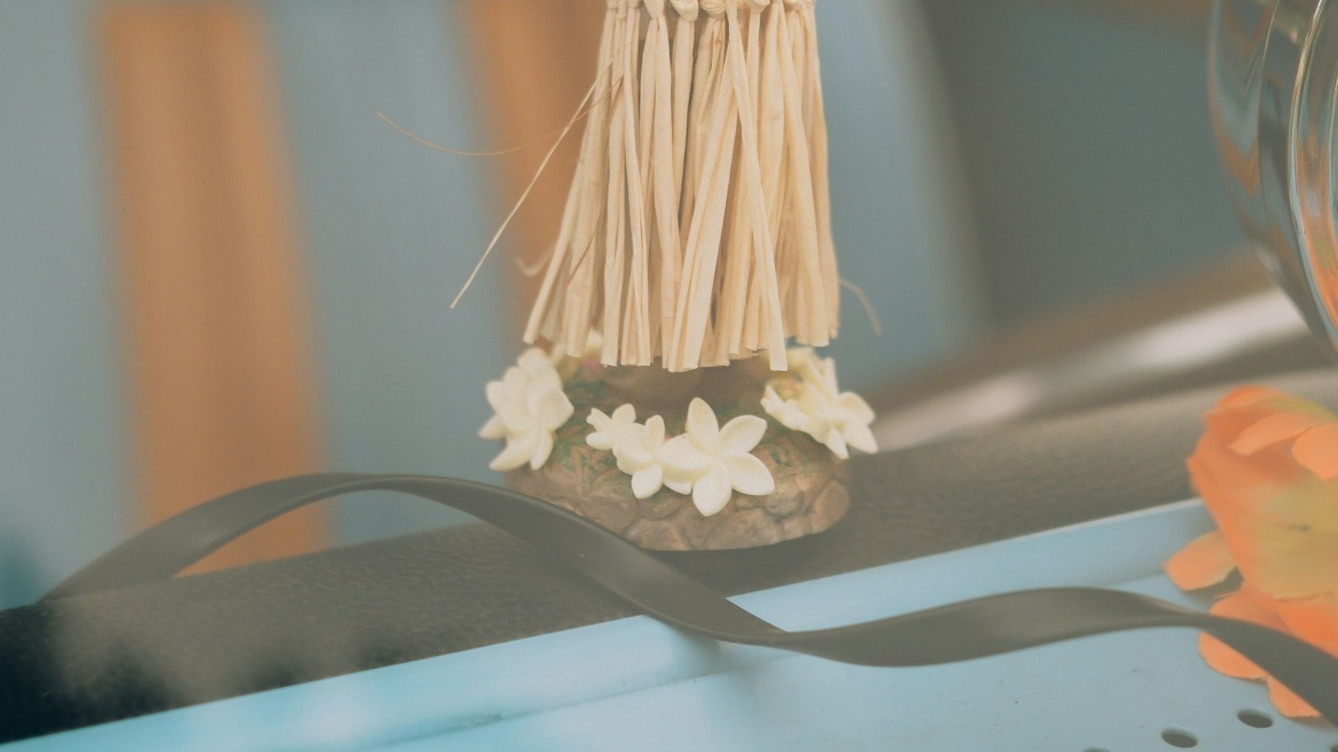 a small figurine of a woman holding a fan