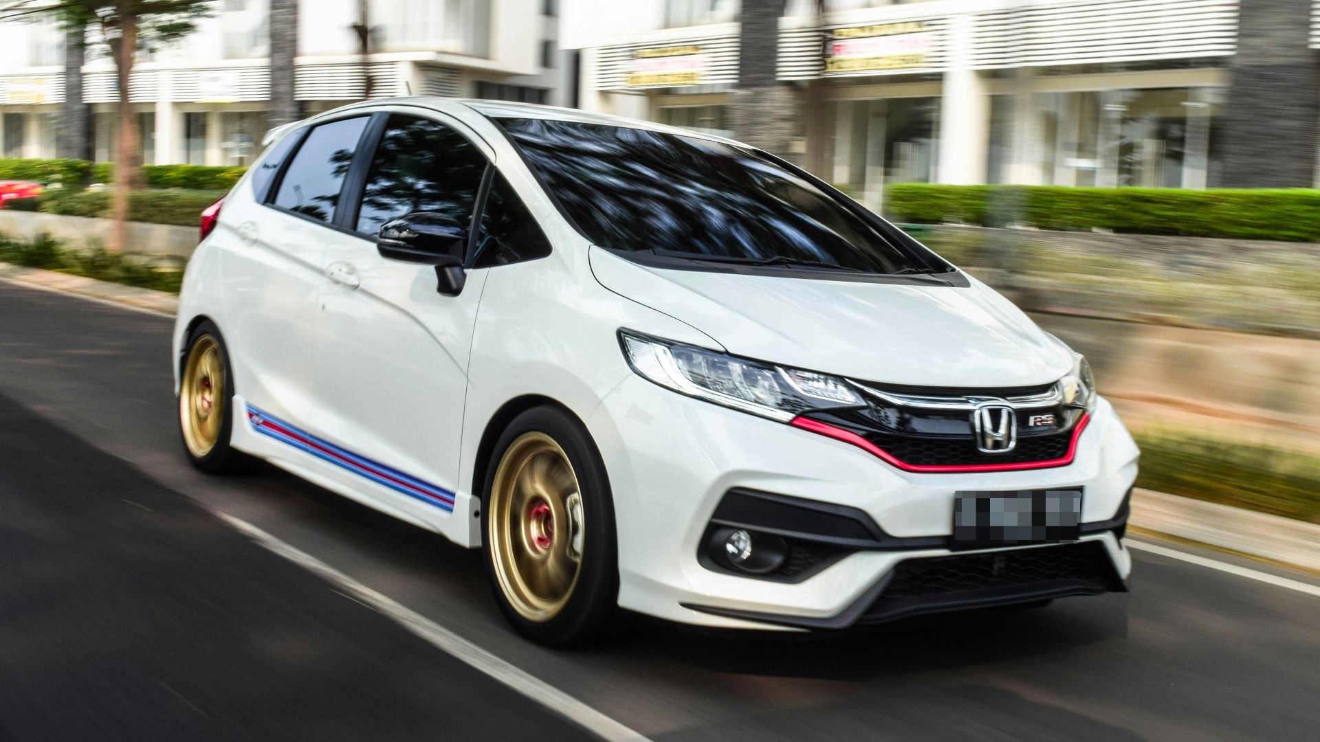 white honda sedan on road during daytime