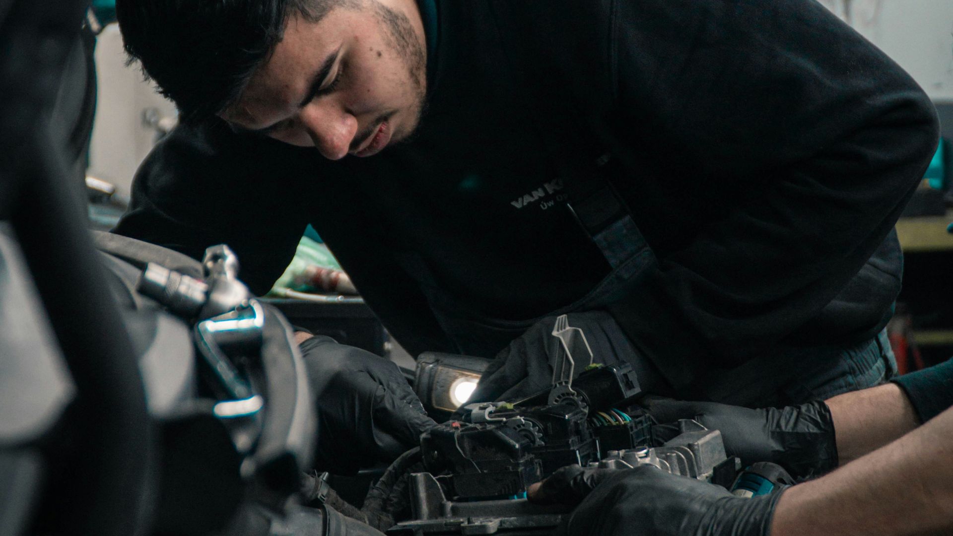 man in black jacket and blue denim jeans riding motorcycle