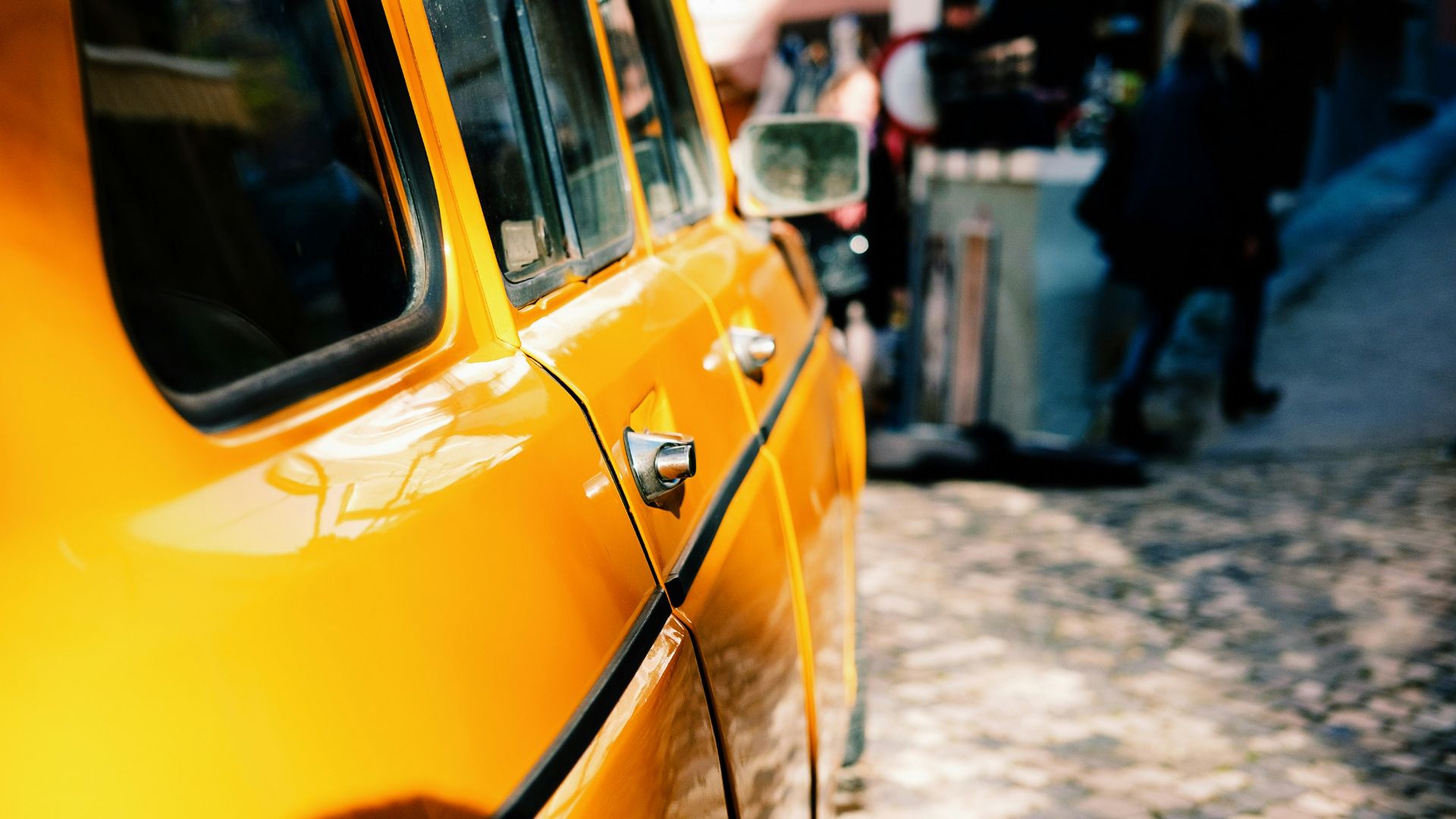 yellow car beside street