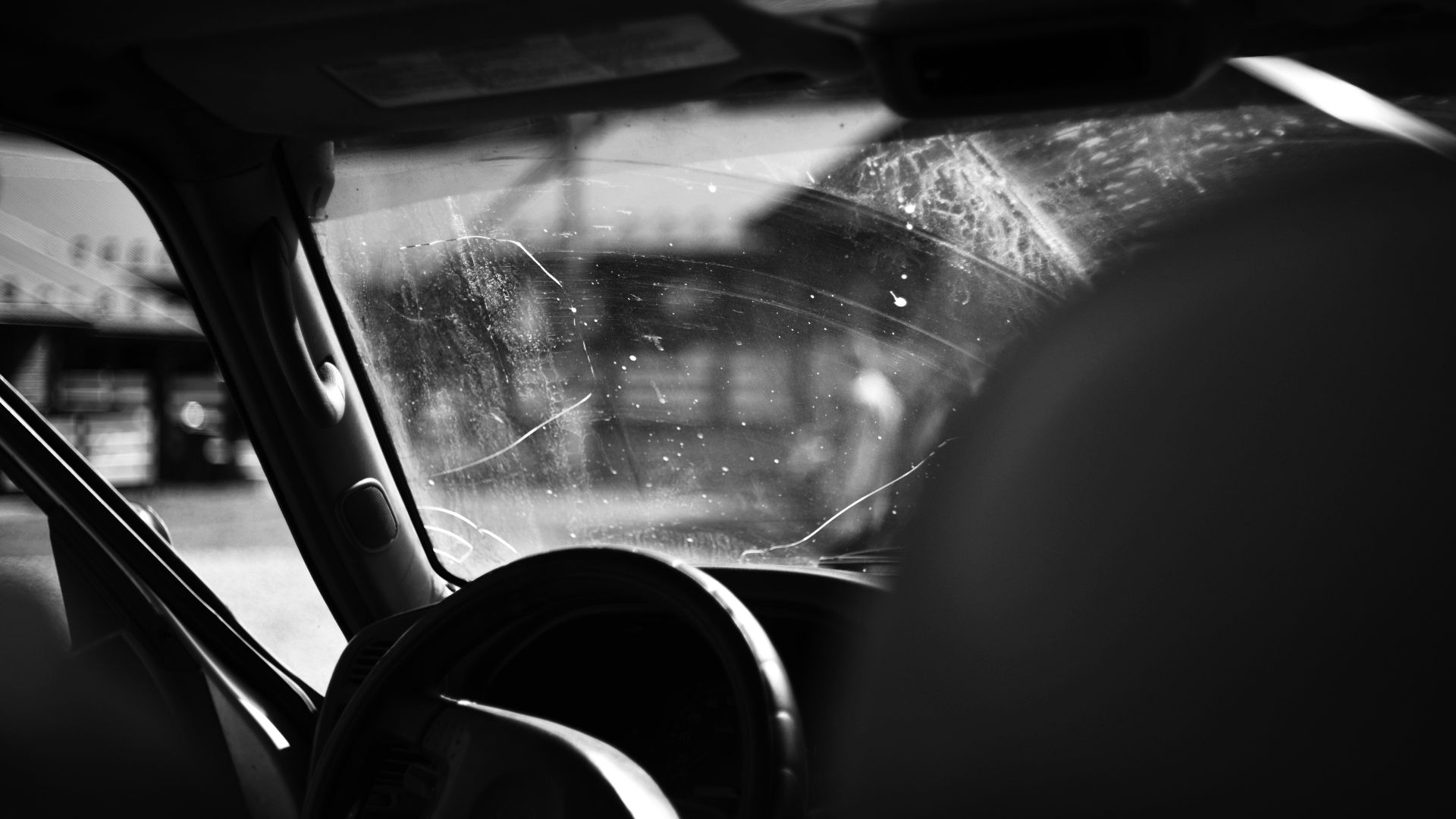 A black and white photo of the inside of a car