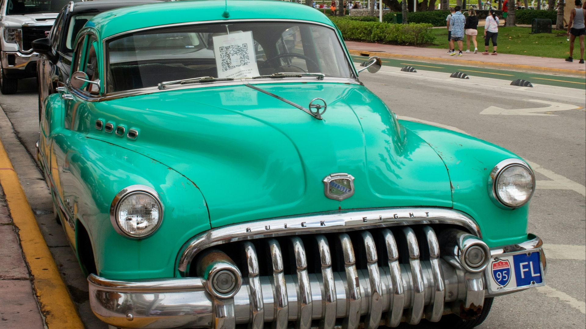 A green car parked on the side of the road