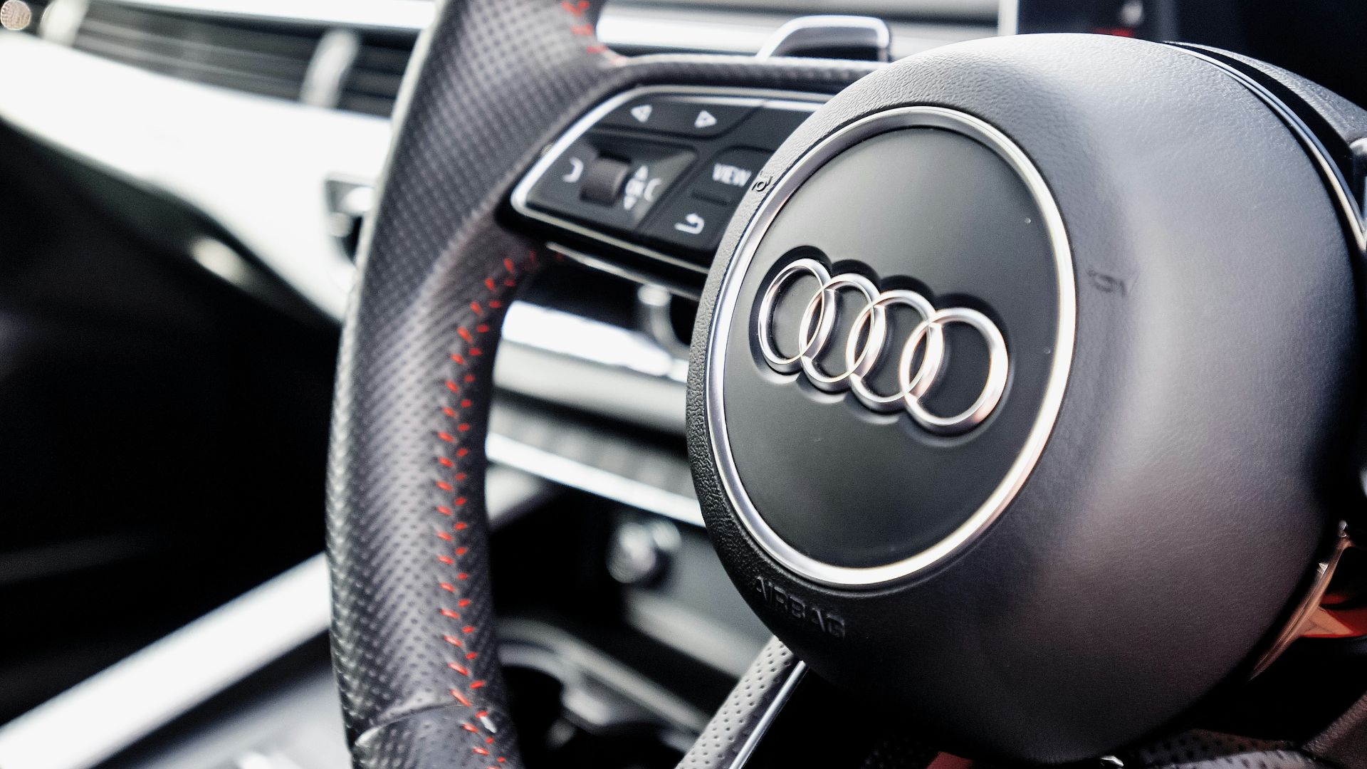 the steering wheel and dashboard of a car