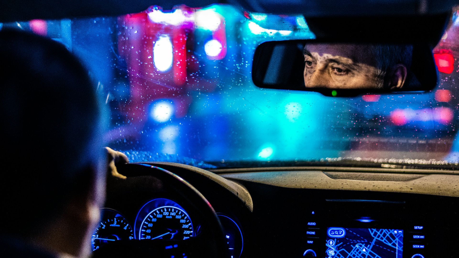 reflective photo of man in rearview mirror