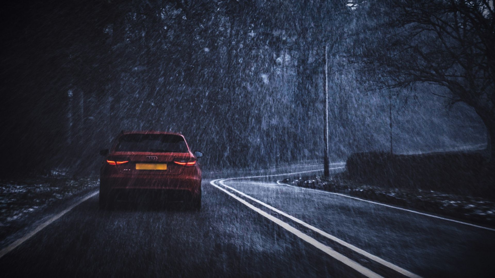 red car on road while raining