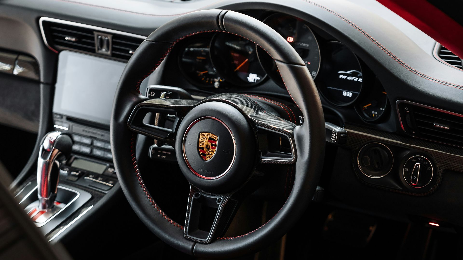 the interior of a sports car with a red carpet
