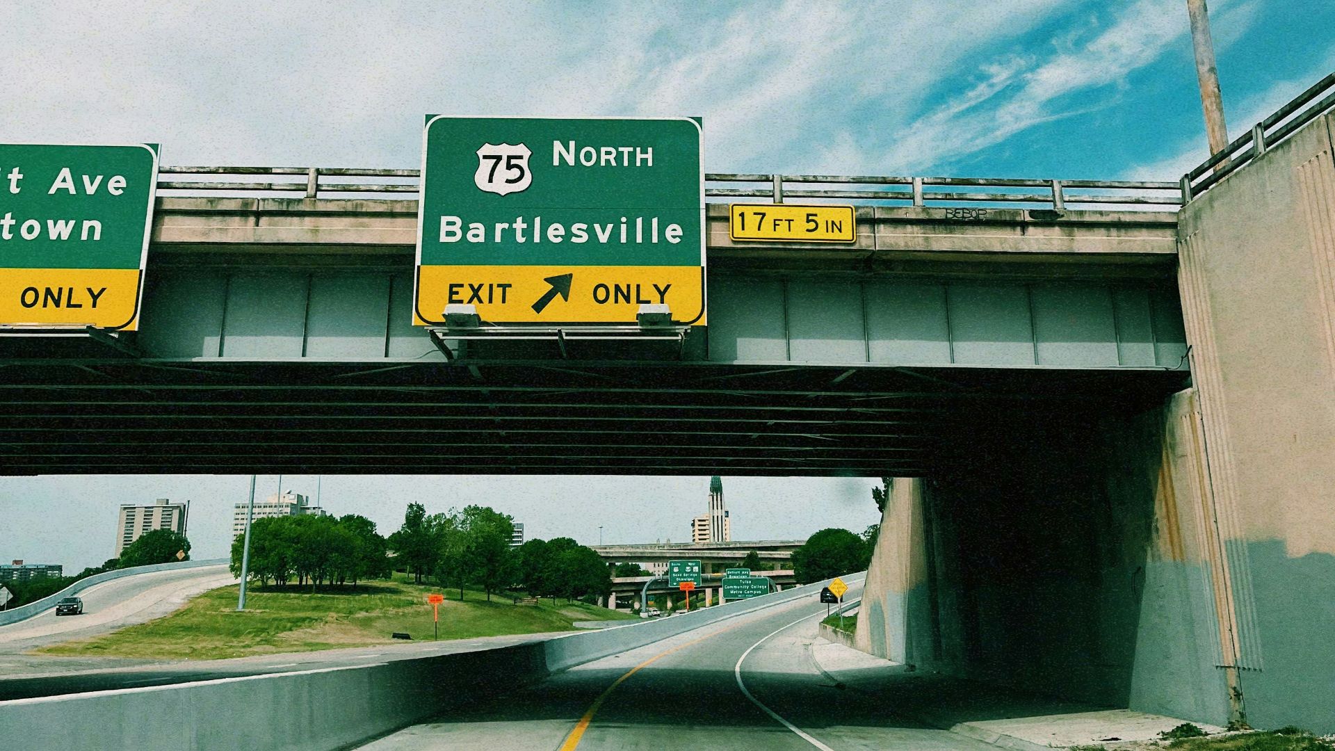 a highway with two freeway signs above it