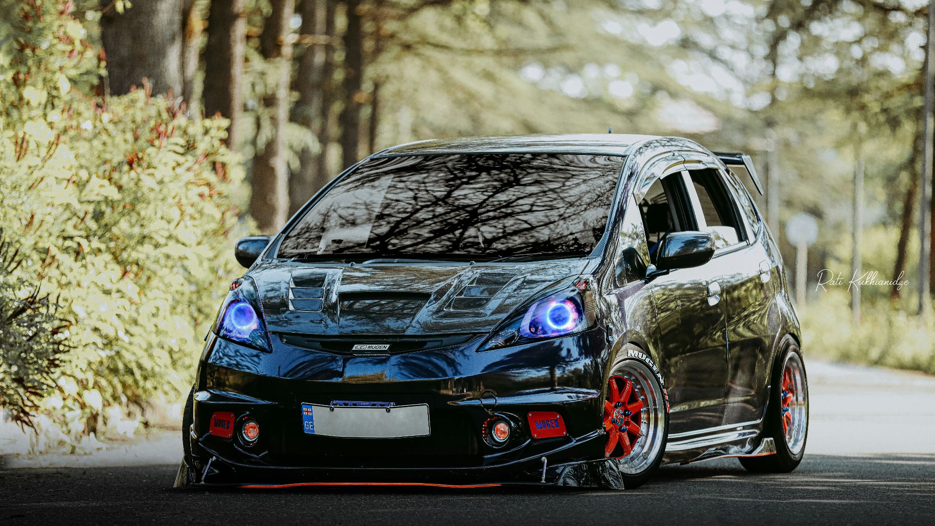 a black car parked on the side of a road