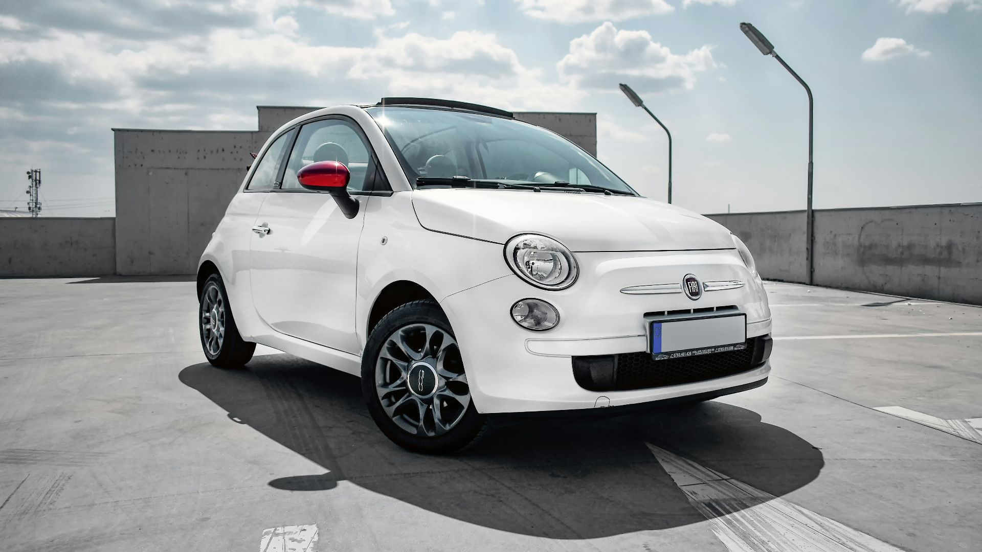 white 3-door hatchback on gray floor