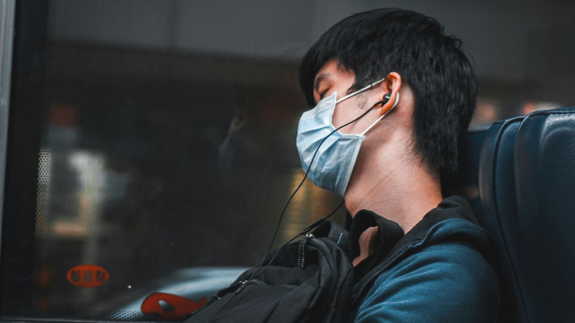 man in black jacket holding smartphone