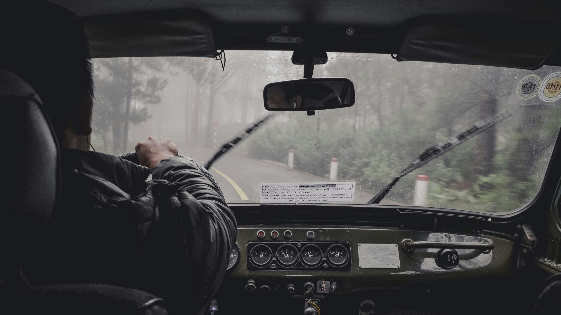 man driving car during rainy daytime