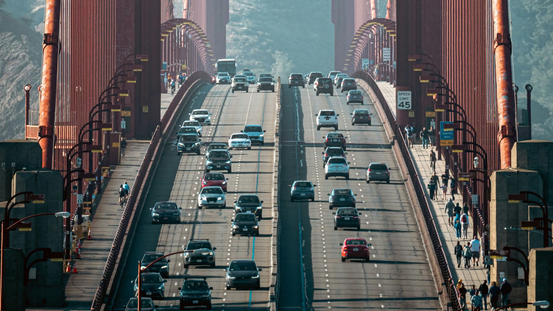 a large red bridge with cars on it