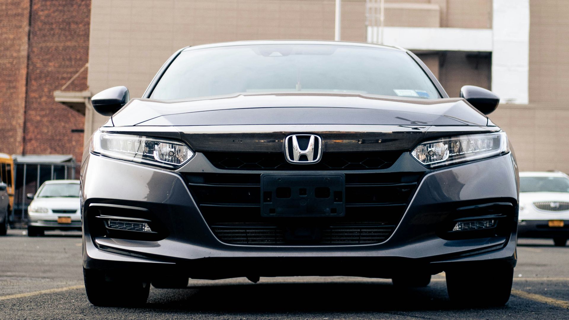 silver mercedes benz car parked on sidewalk during daytime