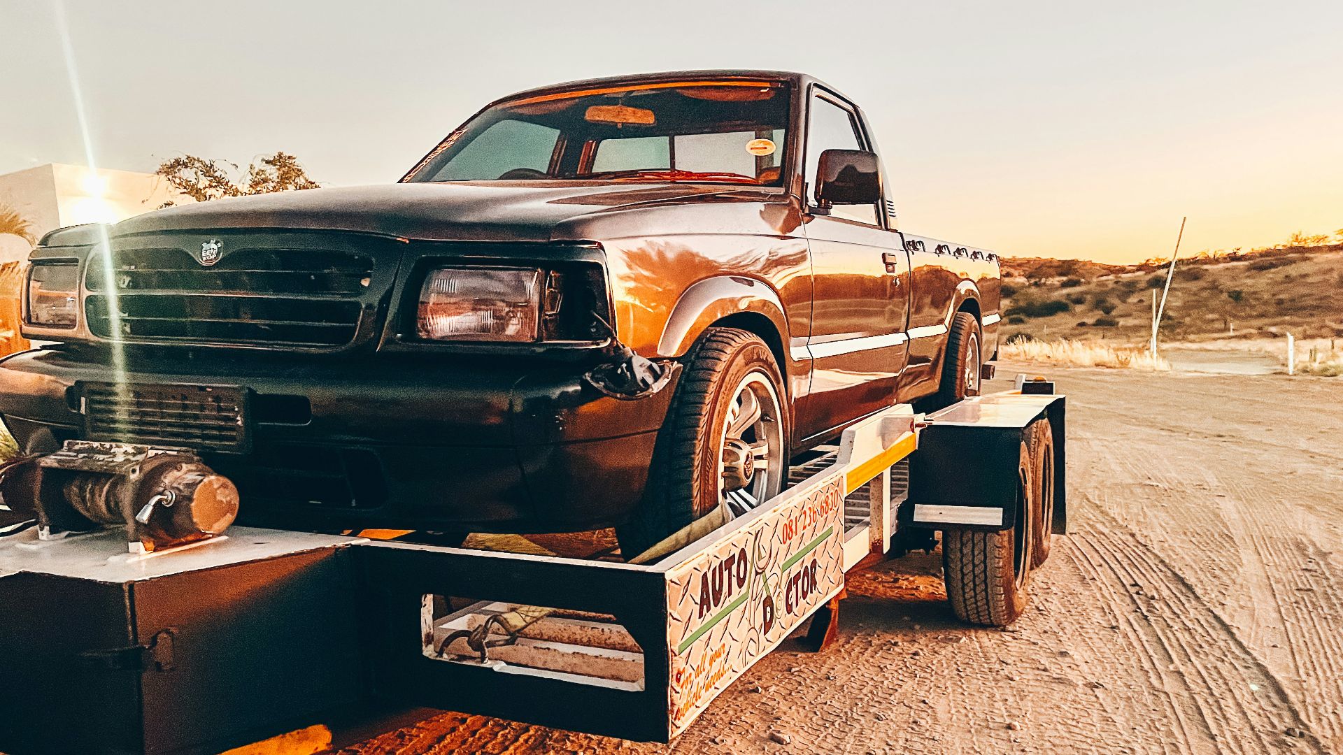 a truck is being towed on a flatbed trailer