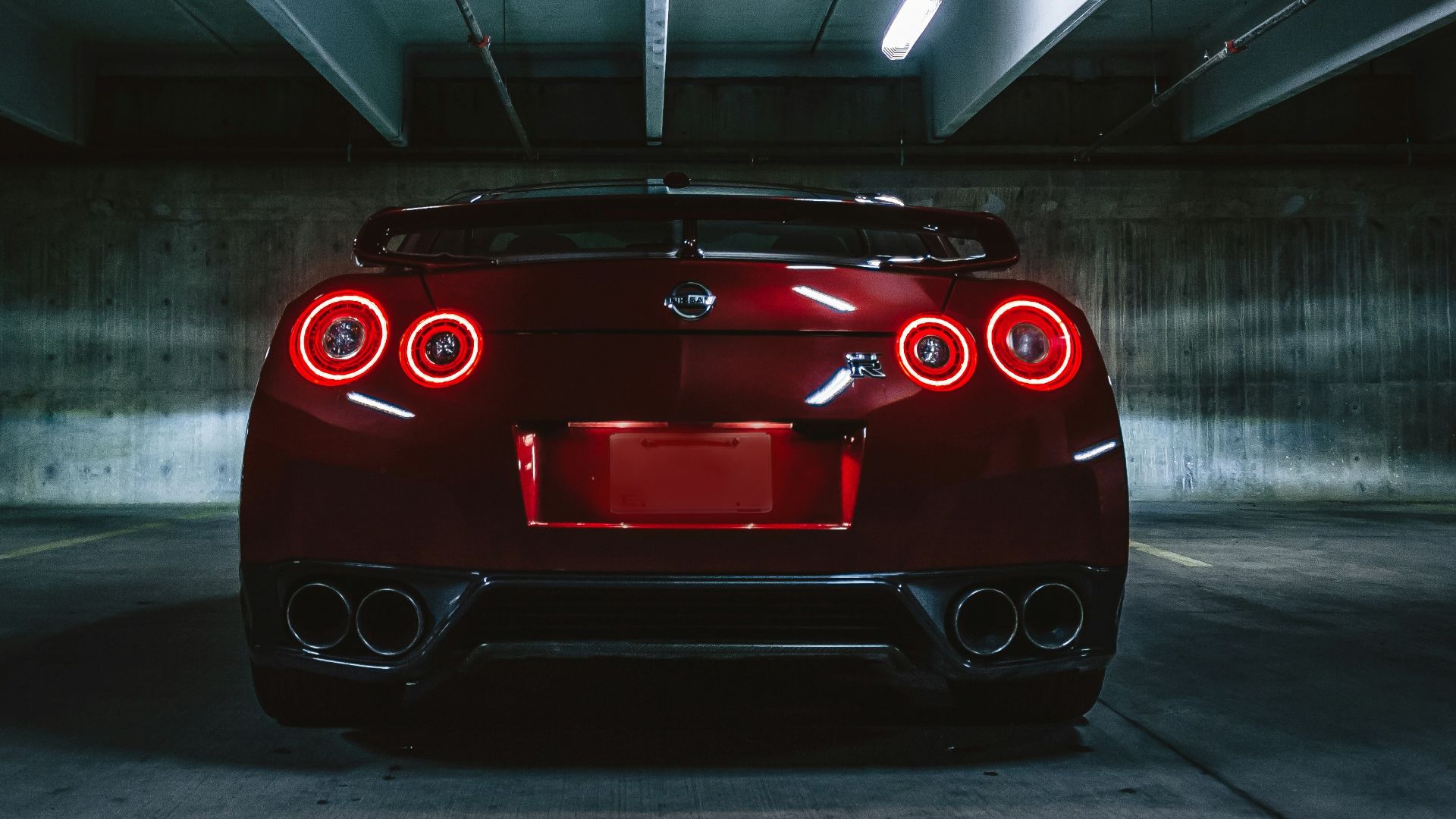 red sports car on concrete flooring