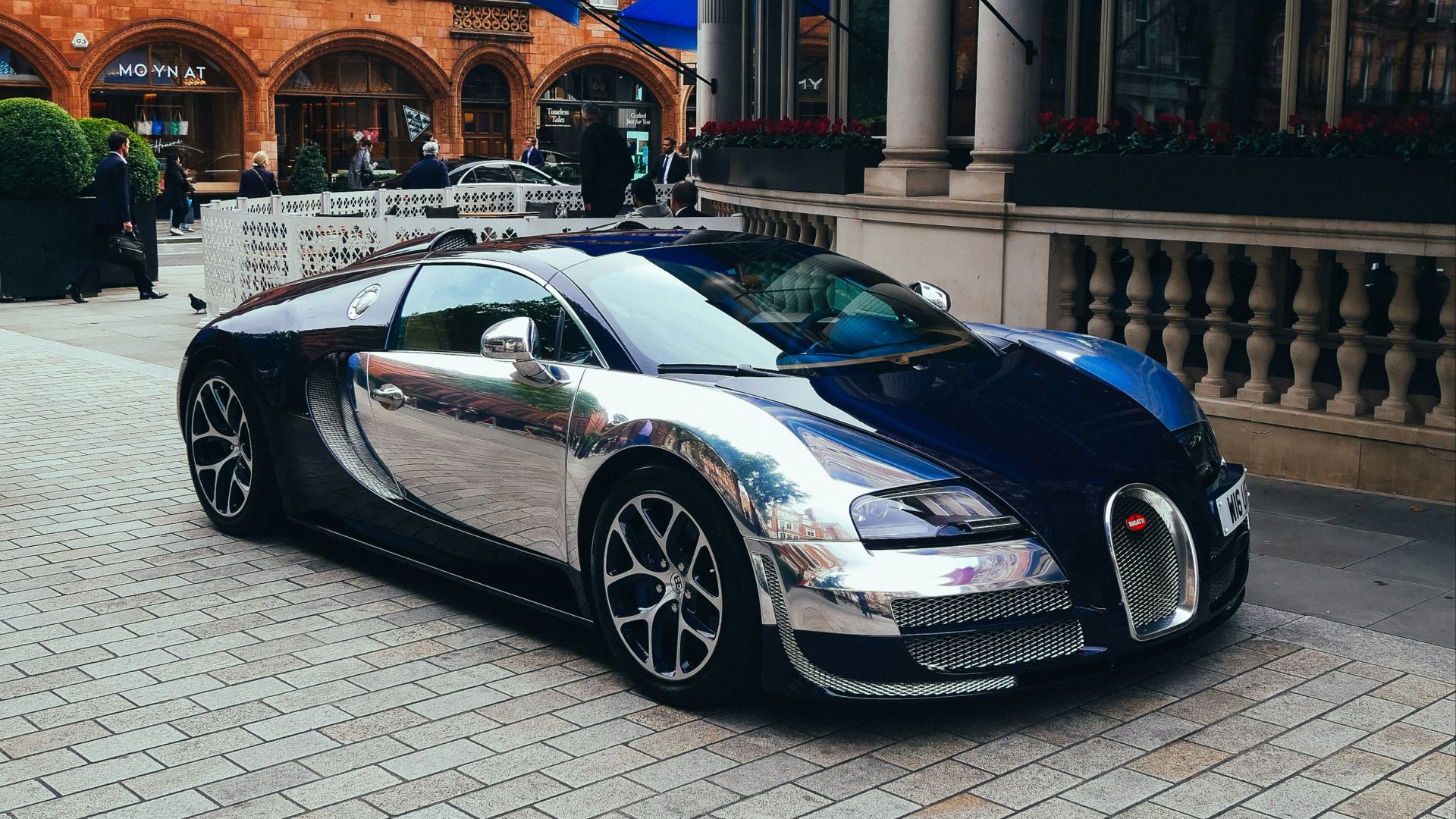 A bugatti is parked in front of a building
