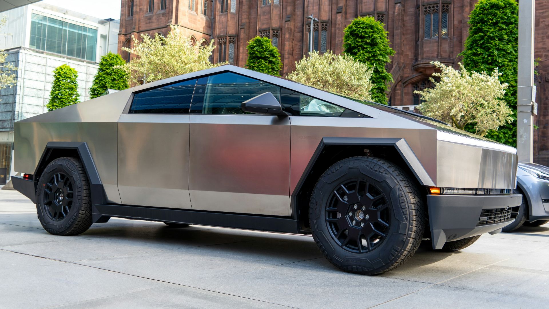 a futuristic car parked in front of a building