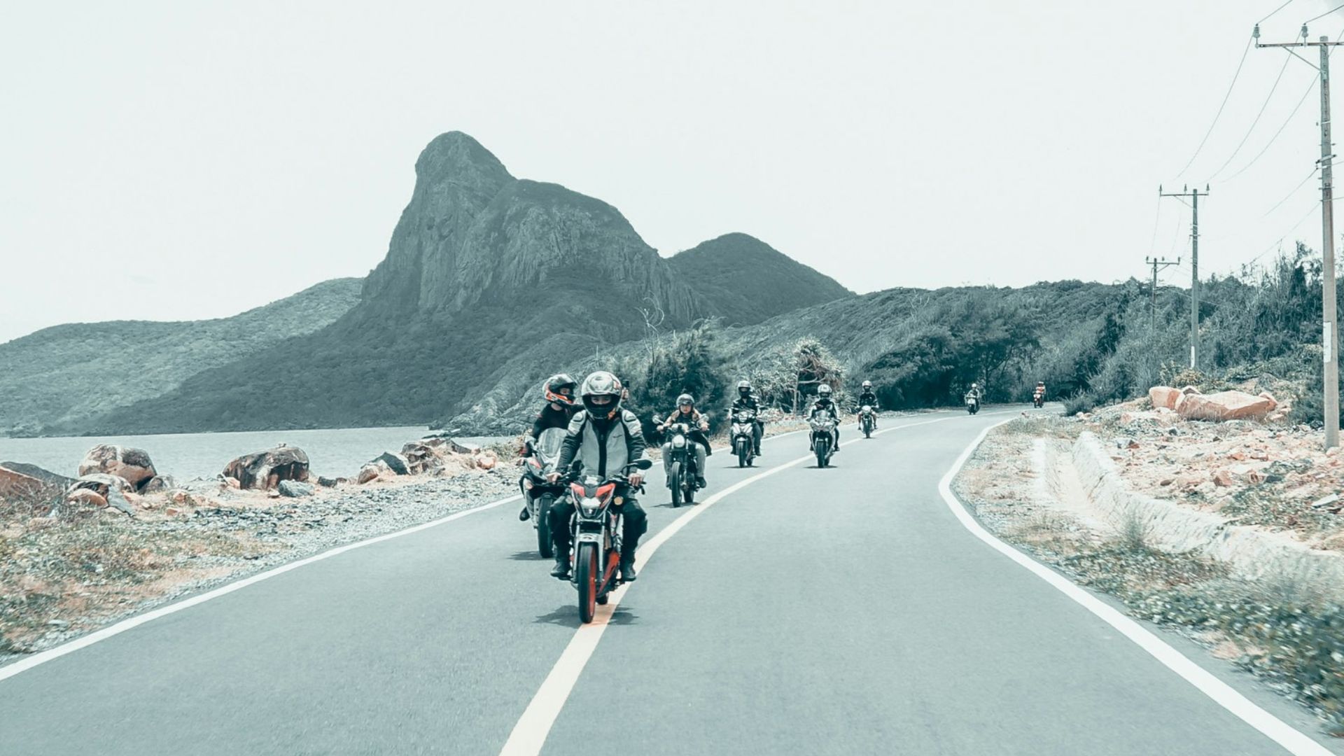 group of people riding motorcycle on road