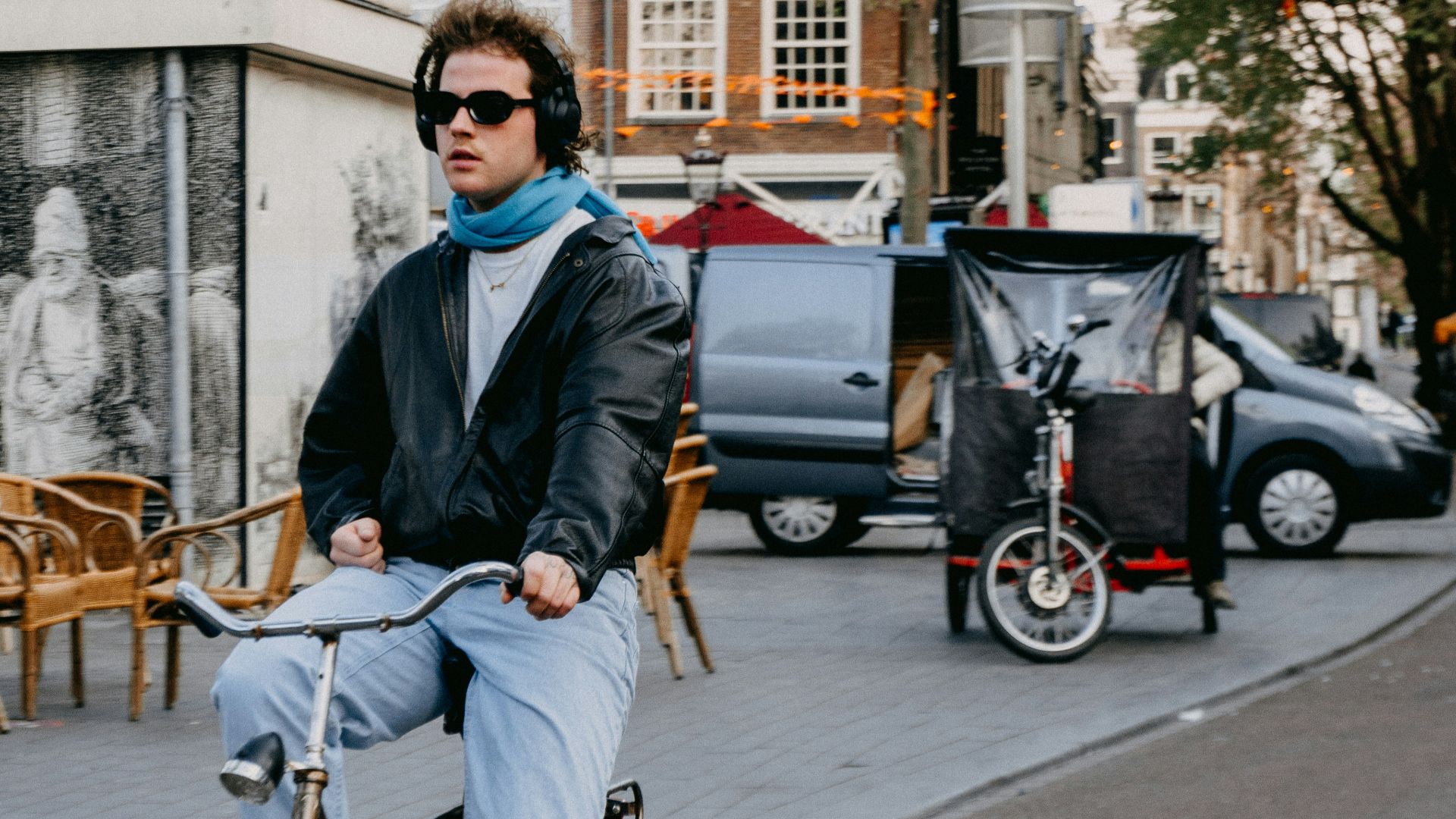 a man riding a bike down a street