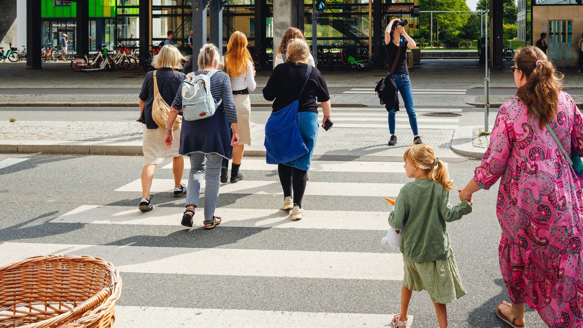 A group of people walking across a cross walk