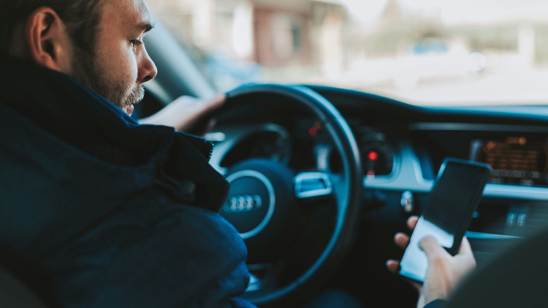 man holding black smartphone