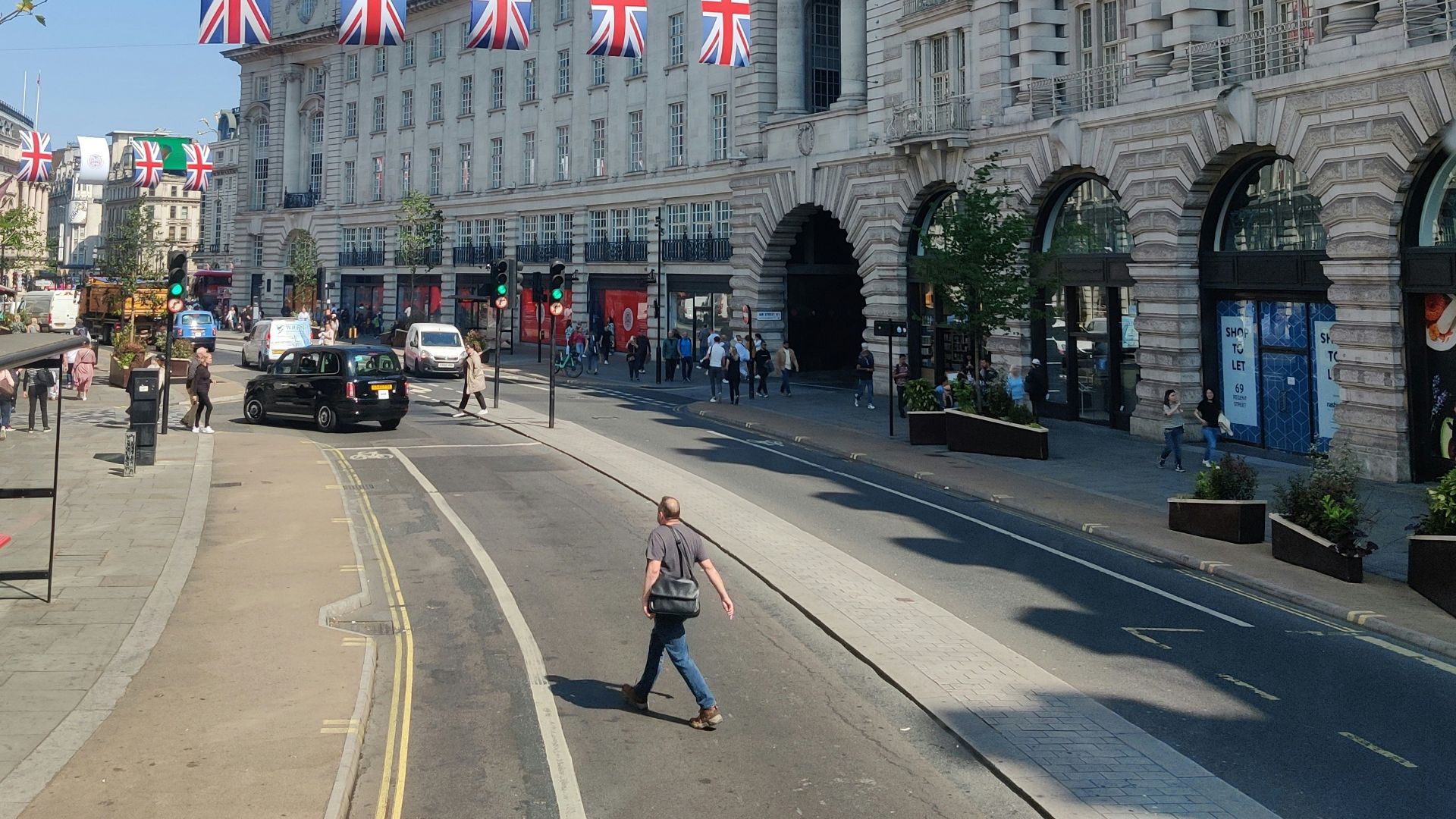a person walking down a street in front of a building