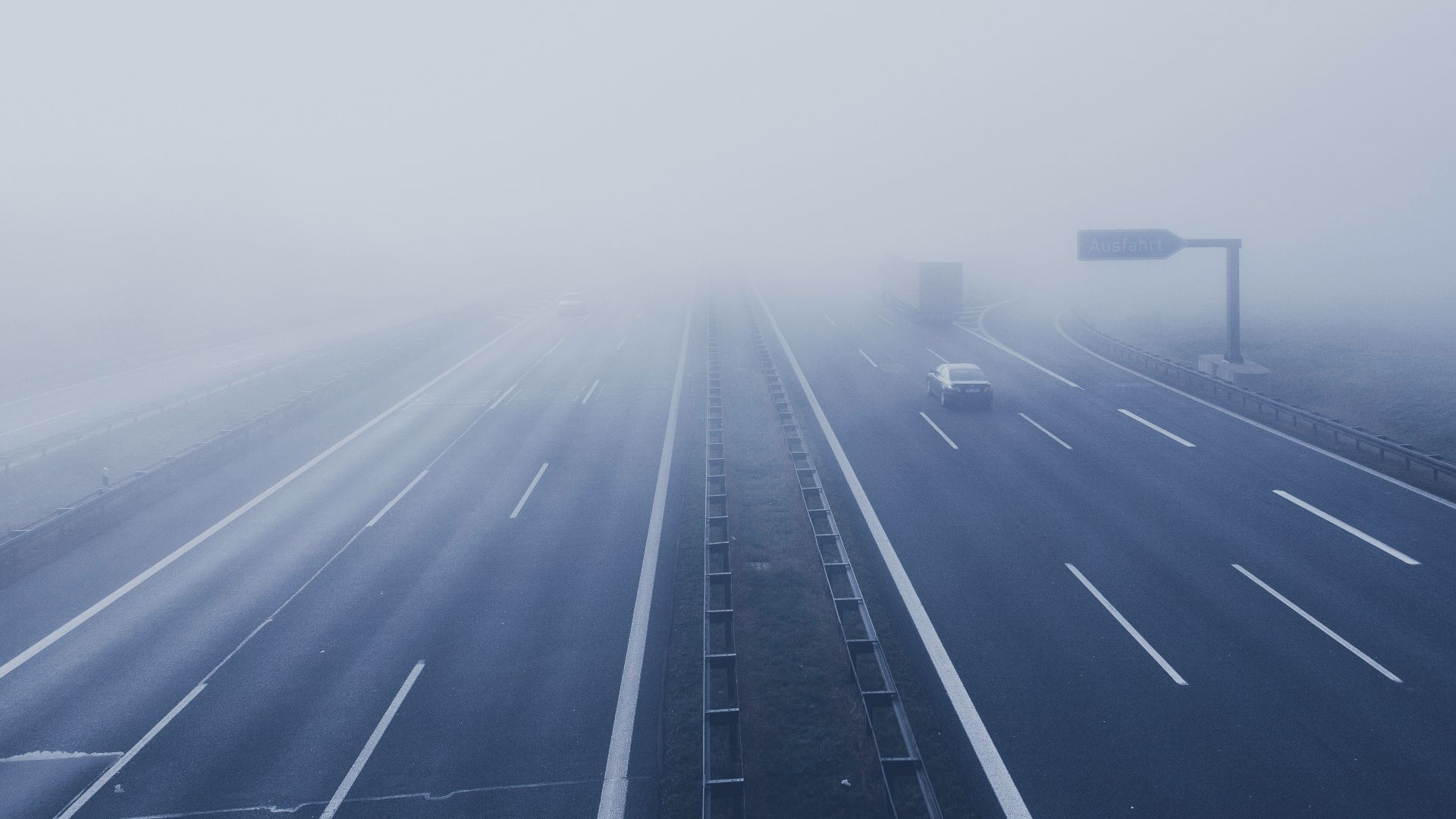road passing by in road while fogging