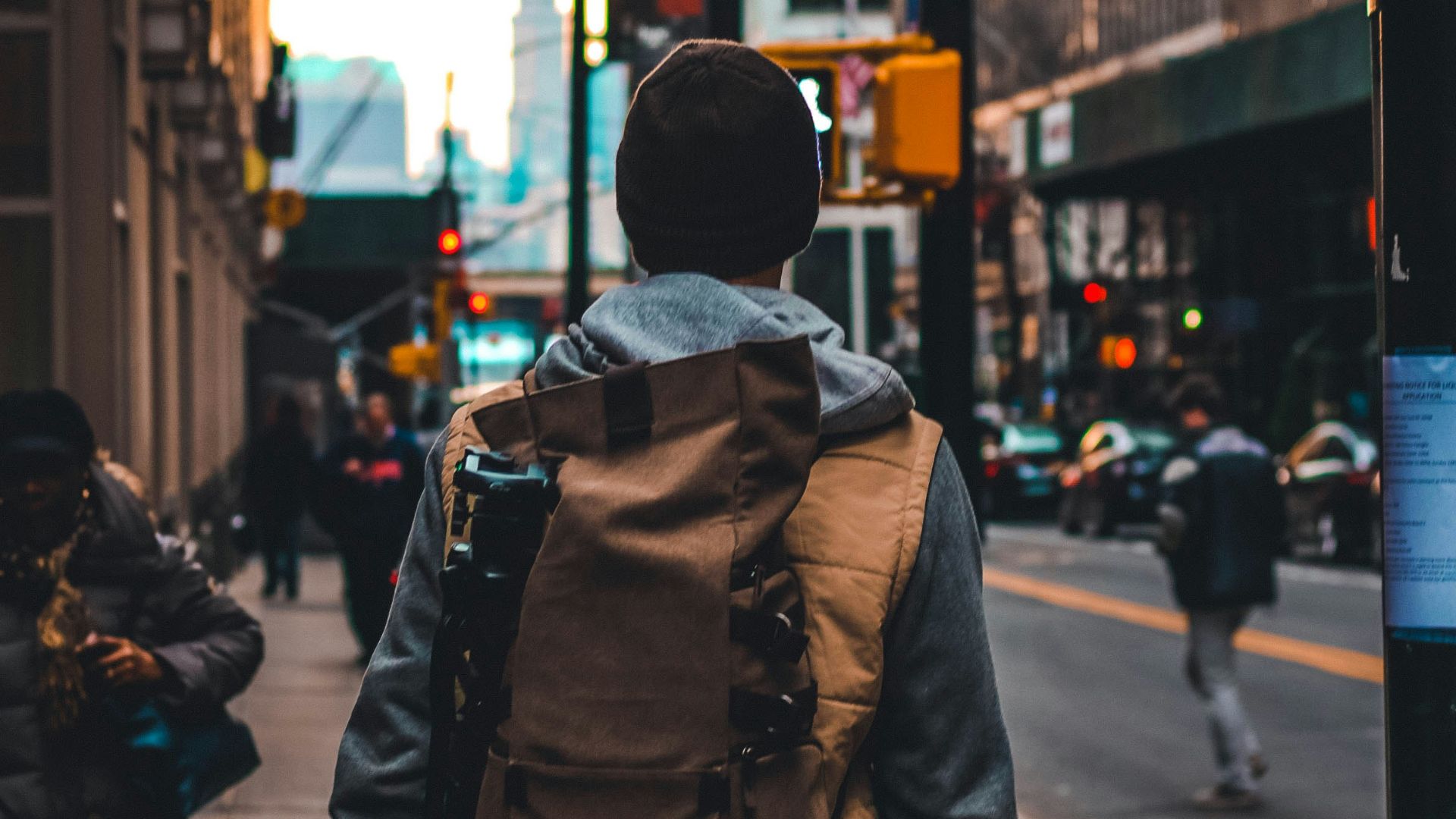 man walking beside road