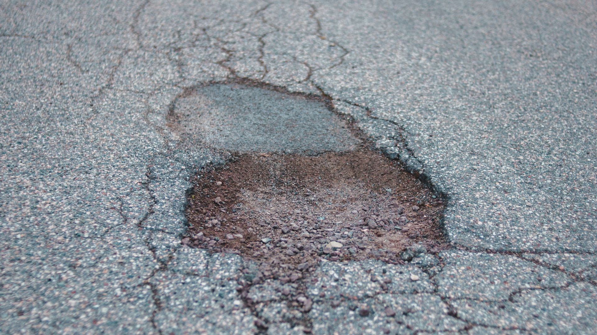 brown rock on gray concrete road