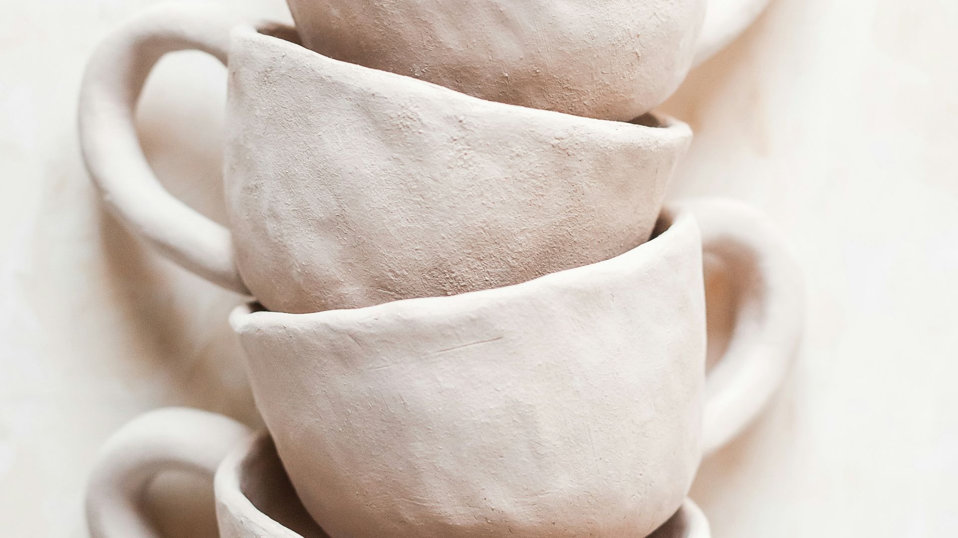 white ceramic mug on white table