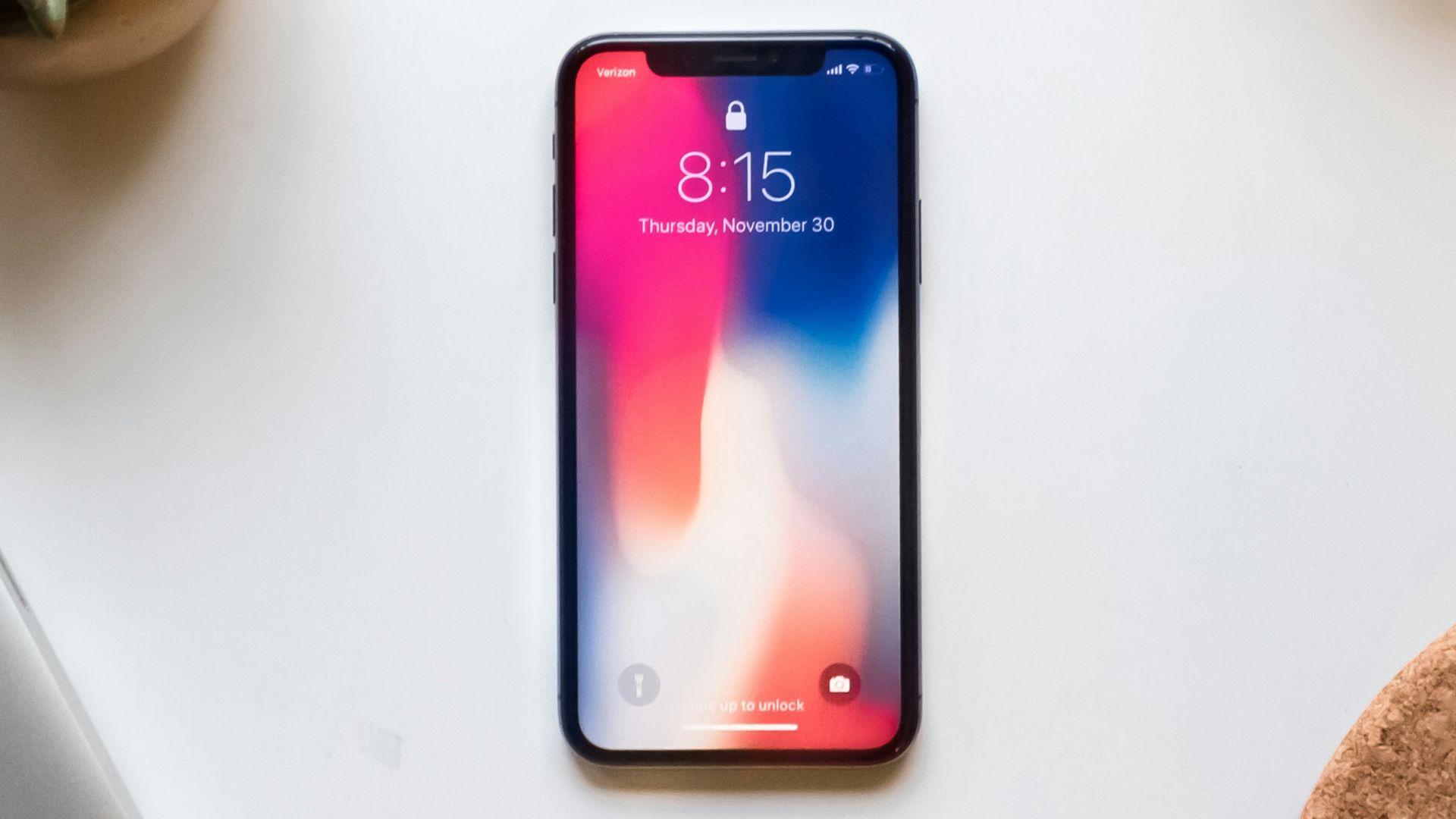 space gray iPhone X near green succulent