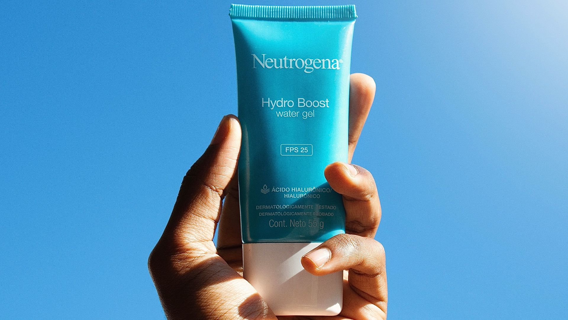 person holding blue and white tube bottle