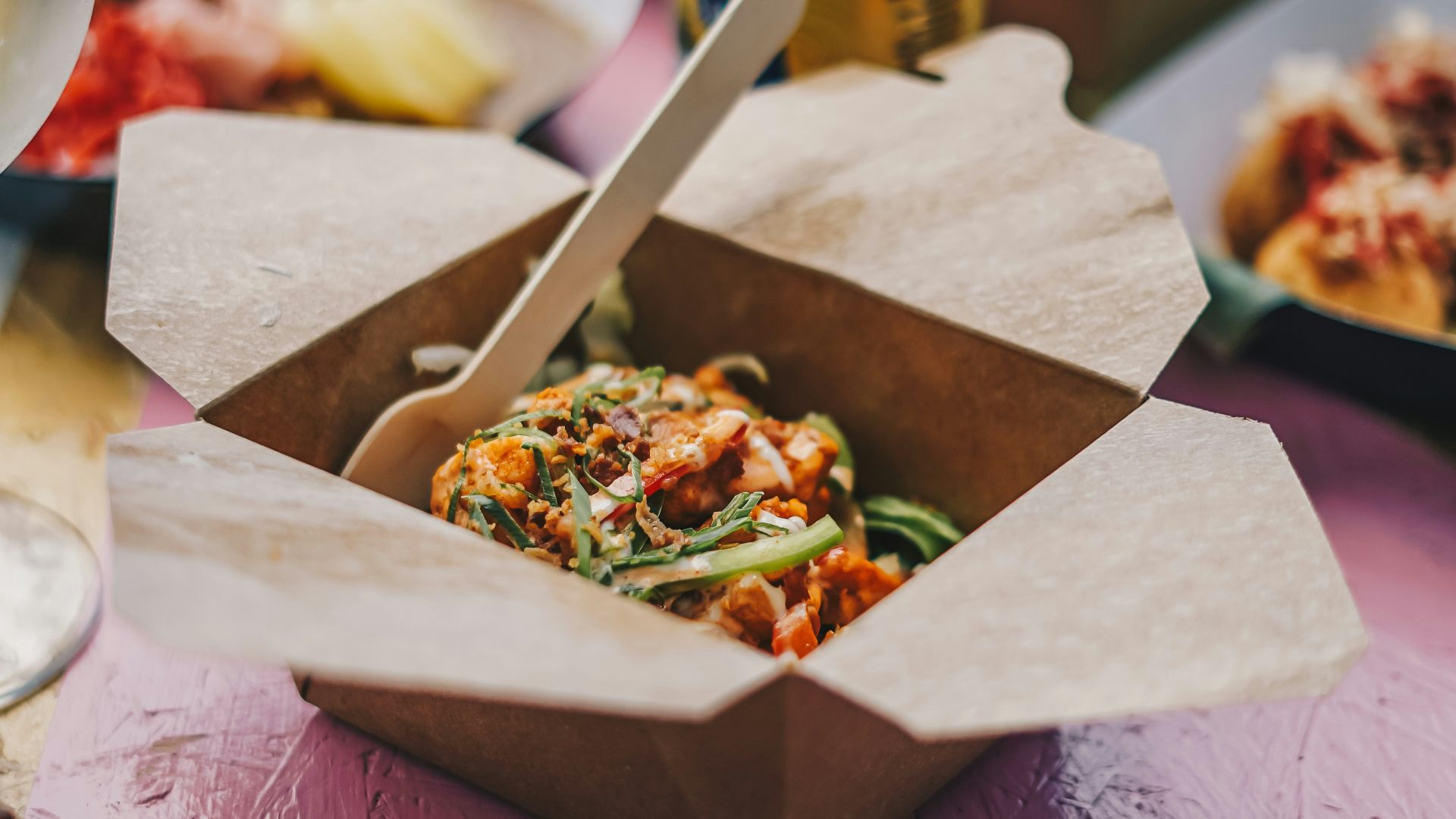 a table topped with boxes of food and drinks